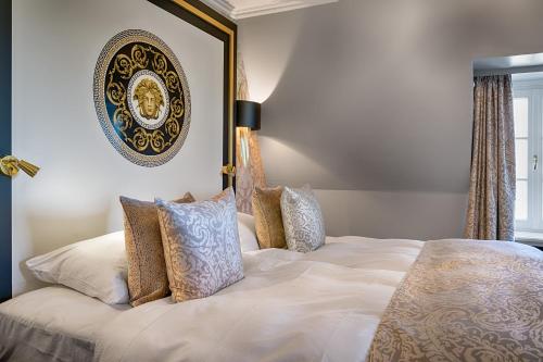 a bedroom with a large white bed with pillows at Parkhotel Adler in Hinterzarten
