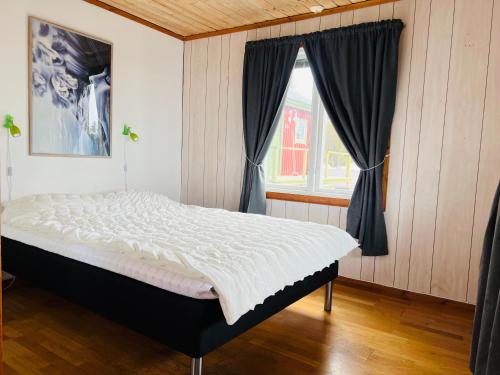 a bed in a room with a window at Camp Alta Kiruna in Kiruna