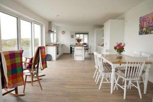 a kitchen and dining room with a table and chairs at Radharc na Mara in Doolin