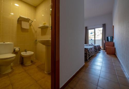 a bathroom with a toilet and a sink at Santa Susanna Resort in Santa Susanna