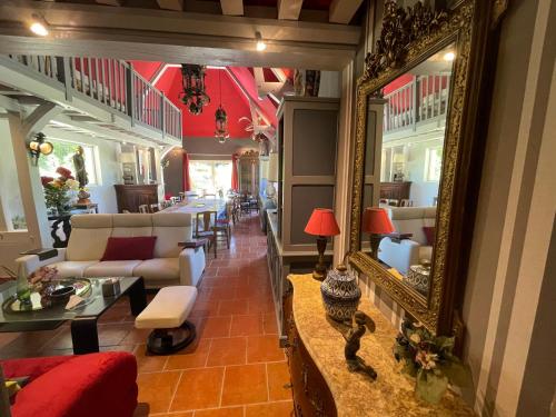 a living room with a large mirror and a couch at LA FONTAINE ROMY in Genneville