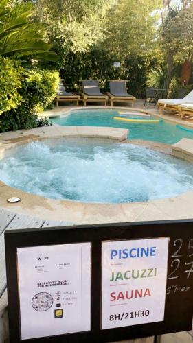 a swimming pool with a sign in front of it at La Villa Saint Jean BAS DE VILLA in La Ciotat