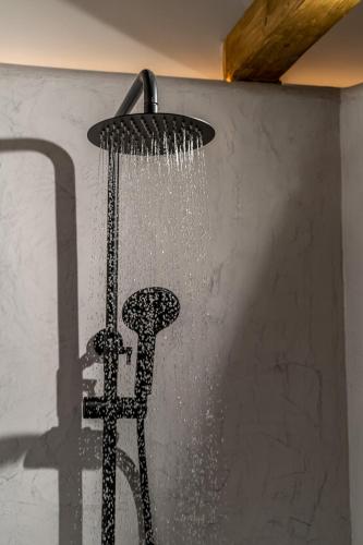 a shower head with water coming out of it at Wine and Yard Caves in Pirgos