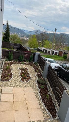 a backyard with a garden with rocks and a driveway at Ubytování Stará in Ústí nad Labem