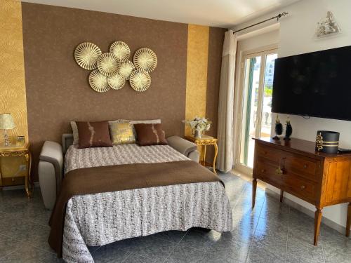 a bedroom with a large bed and a television at Sunderville Superior in Peschici