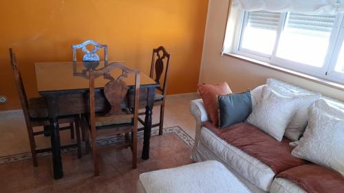 a living room with a couch and a table at Casa rural El Abuelo Arturo in Becerril de la Sierra