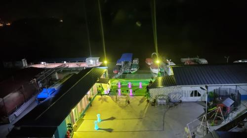 a night view of a parking lot with neon lights at La Marcu Pensiune in Tulcea