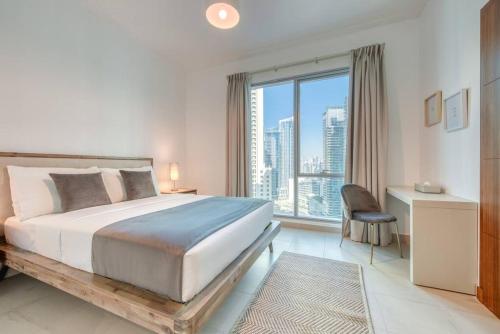 a bedroom with a large bed and a large window at Attessa Tower, Marina Promenade, Dubai Marina - Mint Stay in Dubai