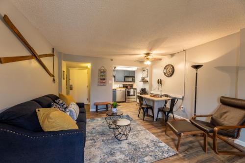 a living room with a couch and a table at Snowshoe Ski-in & Ski-out at Silvercreek Resort - Family friendly, jacuzzi, hot tub, mountain views in Snowshoe