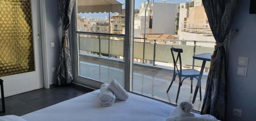 a hotel room with a view of a balcony at Nikis Penthouse in Athens