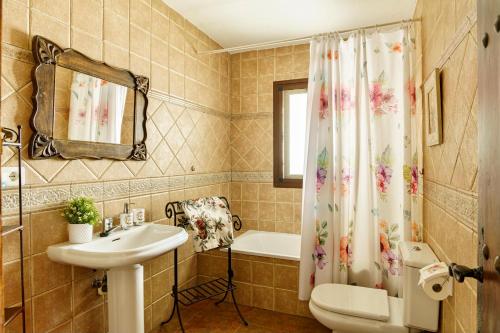 a bathroom with a sink and a shower curtain at Villa Maravillas in Nerja