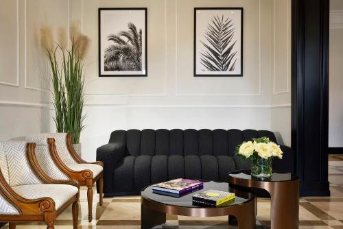 a living room with a couch and a table at Hotel President in Viareggio