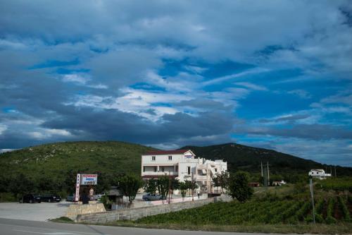 a building on the side of a road with a hill at Apartment Solis (****) in Prgomet