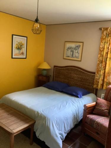 a bedroom with a bed and a chair at Oustal in Savines