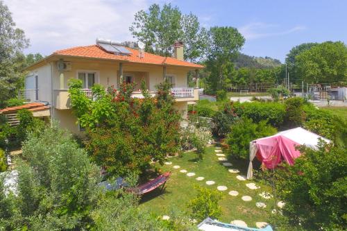 a house with a garden in front of it at Angel Villa - Thassos Town in Limenas