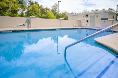 a large swimming pool with blue water at Holiday Inn Express & Suites - Rock Hill by IHG in Rock Hill