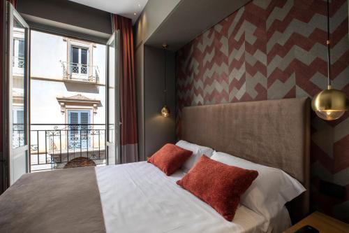 a bedroom with a bed and a large window at Re Sale Boutique Hotel in Trapani