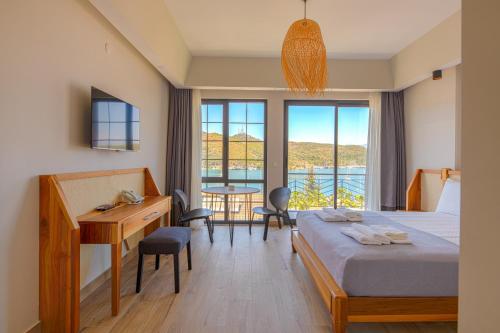 a bedroom with a bed and a desk and a table at Bliss Suites & Hotel in Fethiye