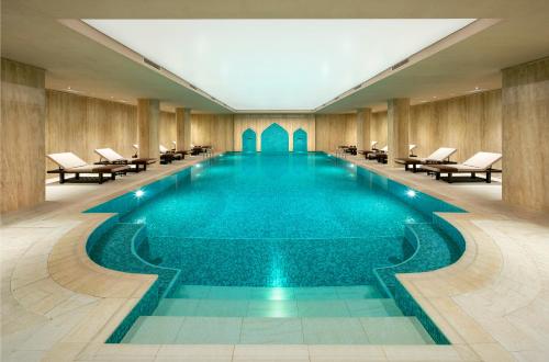 a swimming pool in a hotel with chairs and tables at AJWA Cappadocia in Urgup