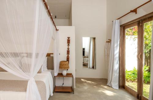 Ένα ή περισσότερα κρεβάτια σε δωμάτιο στο Villa dos Nativos Boutique Hotel