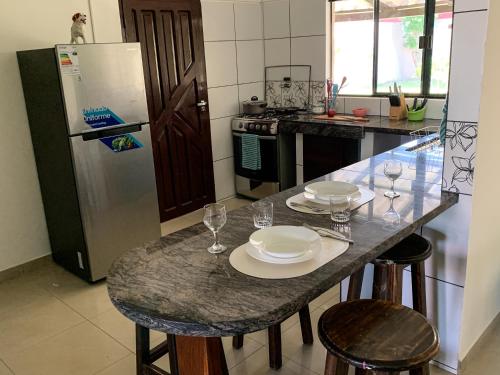 a kitchen with a table with plates and wine glasses at Casa Completa para Familias o Grupos in Santa Cruz de la Sierra