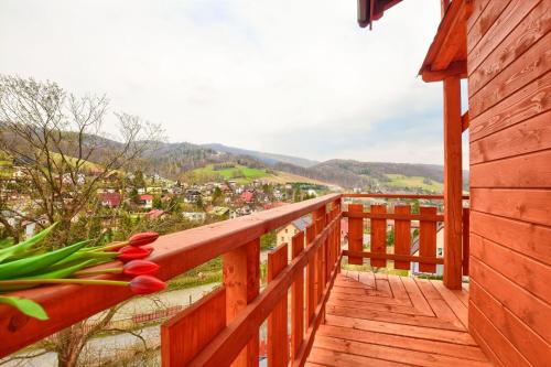 a wooden balcony with a view of a town at Apartamenty Soszów in Wisła
