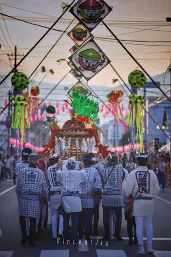 a group of men in uniform walking down a street at Furano CUBE SUGAR-方糖民宿,步行8min到雪场,3 brs,Max 6ppl in Furano