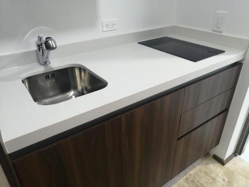 a kitchen with a sink and a counter at GM Luxury Condo Playa del Carmen in Playa del Carmen