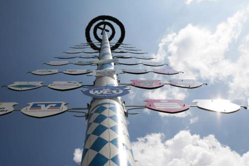 a pole with a bunch of signs on it at Landgasthof Pauliwirt in Erharting