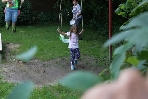 a little girl swinging on a swing at Landgasthof Pauliwirt in Erharting