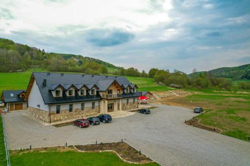 an aerial view of a large house with a parking lot at Bacówka Polany in Polany