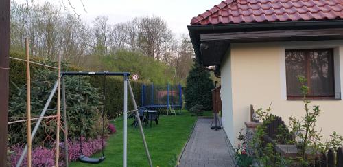 a garden with a house with a fence and a patio at Ubytování Benátky u Litomyšle in Litomyšl
