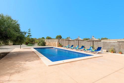 a swimming pool with lounge chairs and a fence at Sa Punta -Sa Punta Bertumins- in Ses Salines