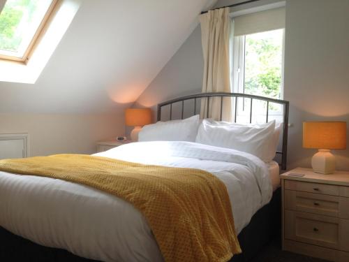 a bedroom with a bed with white sheets and a window at ** SPECIAL OFFER ** Half price - Book your Double room with us now in Willand