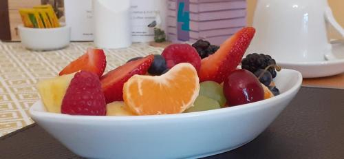 a white bowl filled with fruit on a table at The Briarfields in Torquay