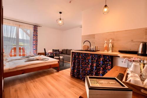a room with a bed and a living room at Apartamenty Soszów in Wisła