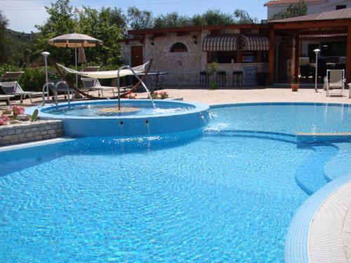 a large swimming pool with a fountain in the middle at Agriturismo I Tesori del Sud Vieste, Puglia in Vieste