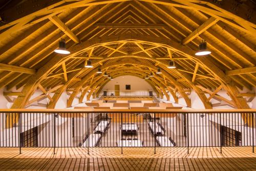 a large room with a large wooden ceiling at Penzion Panský dvůr Telč in Telč