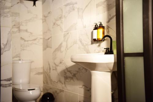 a bathroom with a sink and a toilet at Hacienda San Patricio in San Miguel de Allende