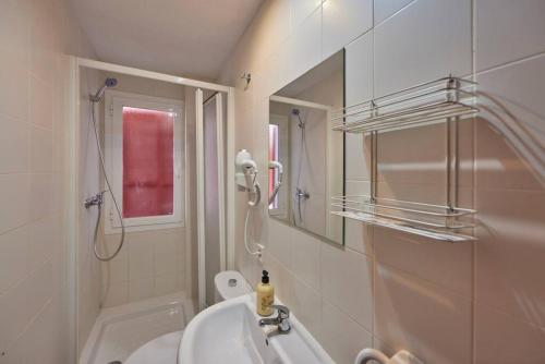 a bathroom with a sink and a toilet and a mirror at Nura Houses Apartment Magaluf 3 in Magaluf