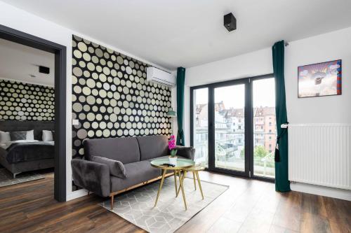 a living room with a couch and a table at Eco Smart Apartments Premium City in Nuremberg