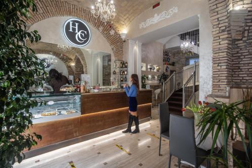 a woman standing at the counter of a bakery at Hotel Centro Cavour Roma in Rome