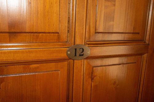 a wooden door with the number on it at Radics Panzió Étterem és Pihenő Központ in Letenye