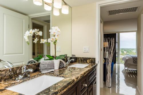 a bathroom with two sinks and a large mirror at Ocean Beach Condo 3BR On the Sand 811 in Fort Lauderdale