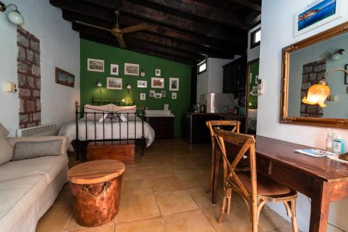 a living room with a couch and a table and a bed at Rafalias Mansion in Hydra