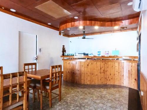 a dining room with a table and chairs and a counter at Ocean Vista Maldives,Maafushi in Maafushi
