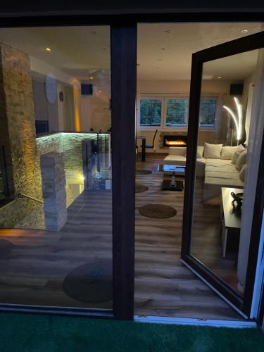 a mirror in a room with a living room at Luxus Resort - Zupko in Fiľakovo