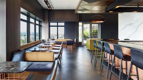 a dining room with tables and chairs and a large window at Andaz Ottawa Byward Market-a concept by Hyatt in Ottawa