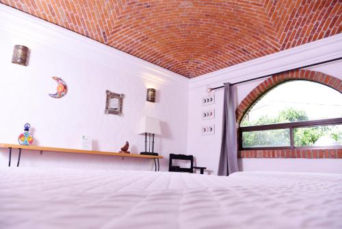 a bedroom with a bed with a brick ceiling at Hacienda San Patricio in San Miguel de Allende