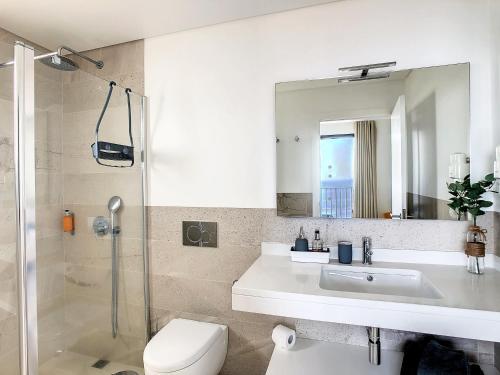 a bathroom with a sink and a toilet and a mirror at Eden Sky by LovelyStay in Prazeres